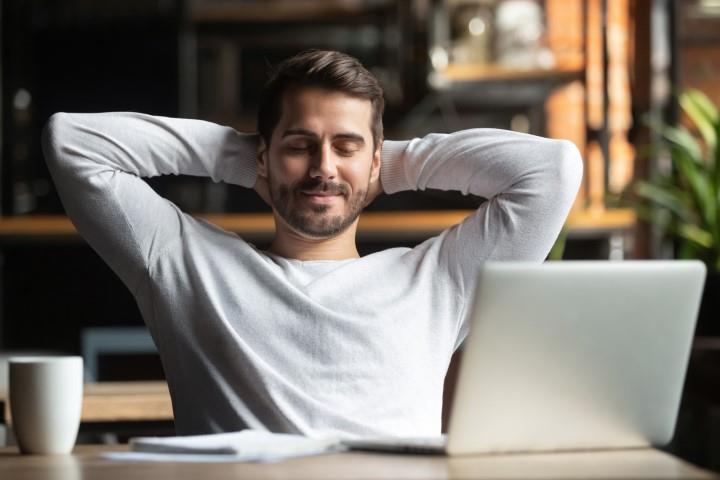 working on a laptop with a cup of coffee
