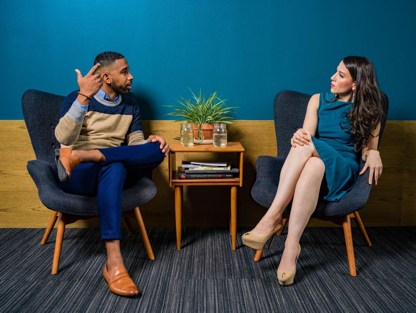 Two people sitting on a chair
Description automatically generated